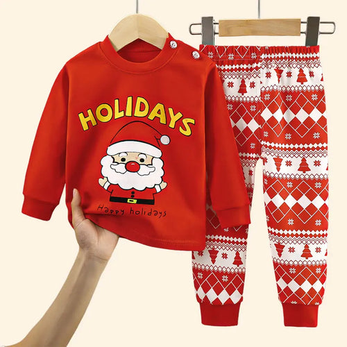 Baby Christmas outfit with red Santa Claus sweatshirt and festive patterned pants.
