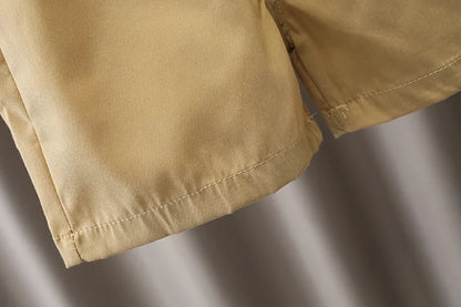 Close-up of beige cotton baby shorts hem, lightweight infant summer clothing