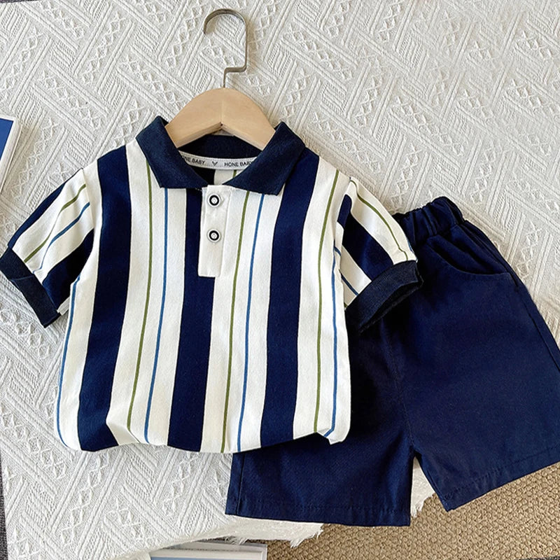 Striped baby boy summer outfit with navy and white short-sleeve polo and navy shorts