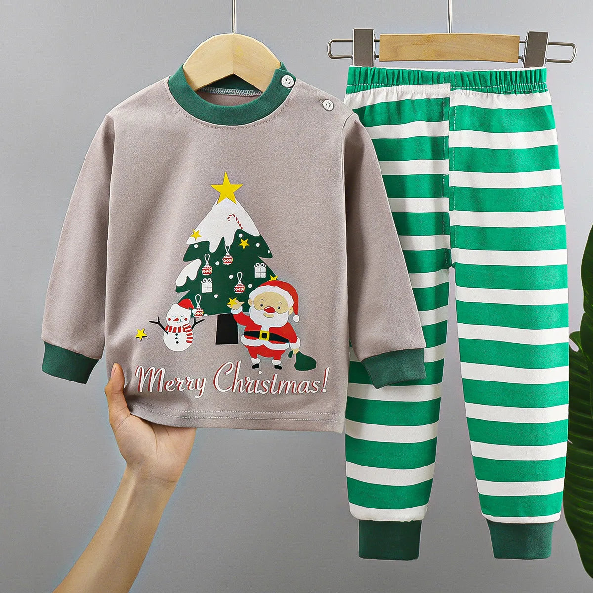 Baby Christmas pajama set with Santa, snowman, Christmas tree, and green striped pants
